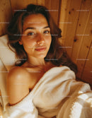 Relaxed Woman Lying on Bed with White Blanket in Cozy Home