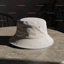 Beige bucket hat resting on stone table indoors