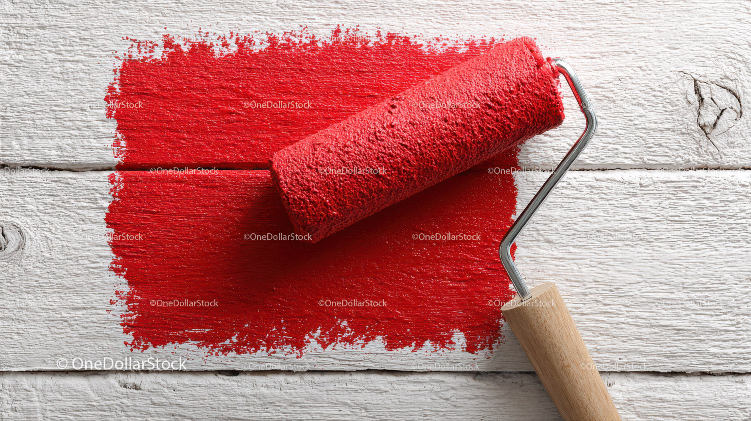 Red Paint Roller on White Wooden Surface for Home Renovation