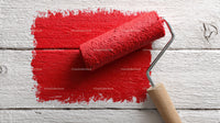 Red Paint Roller on White Wooden Surface for Home Renovation