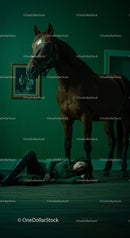Woman Lying on Floor Beside a Horse in Dramatic Green Room