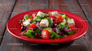 Fresh Vegetable Salad with Cherry Tomatoes and Feta on Red Plate