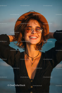 Smiling Woman with Sunglasses Wearing Stylish Jewelry on Beach at Sunset