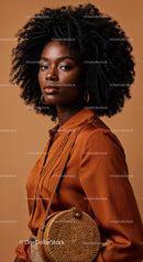 Elegant African American Woman with Curly Hair Wearing Satin Shirt and Round Woven Handbag