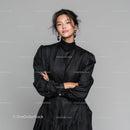 Chic Woman in Elegant Black Dress with Confident Pose