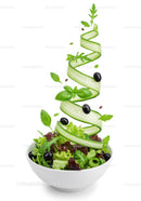 Fresh green salad with spiral cucumber and black olives