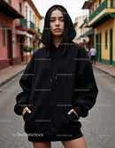 Fashionable Woman Wearing Black Hoodie in Urban City Street