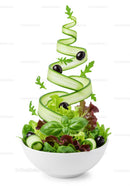 Fresh mixed green salad with floating cucumber ribbons