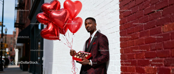 Man Holding Heart Balloons and Chocolates Outdoors