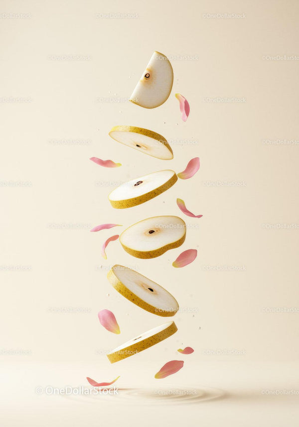 Slices of Asian pear suspended with soft pink petals