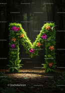 Green floral letter M glowing in dark forest