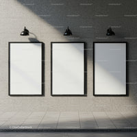 Three blank posters on modern stone wall with lights