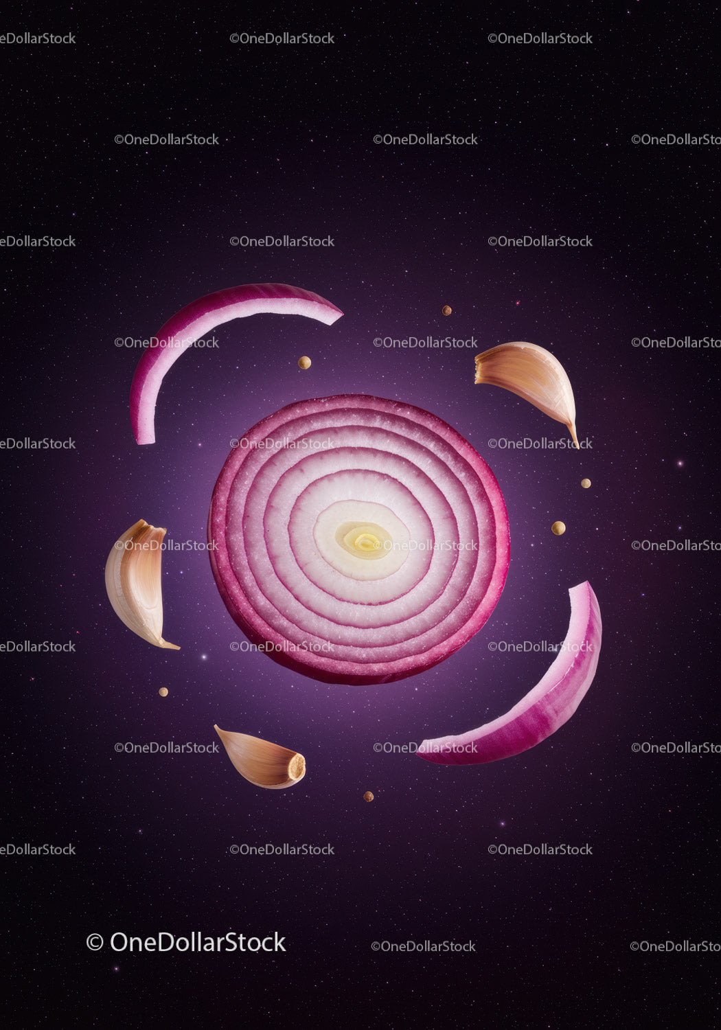 Red onion and garlic cloves floating on dark background