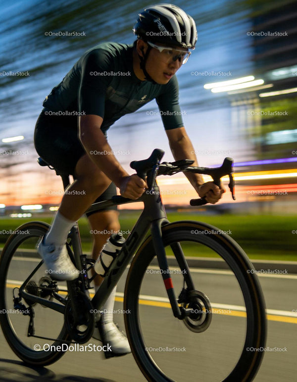 Focused cyclist riding fast during twilight hours