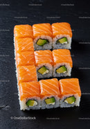 Salmon and Avocado Sushi Rolls Arranged on Black Slate