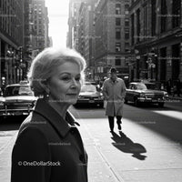 Elegant Elderly Woman Walking in Business District on City Street