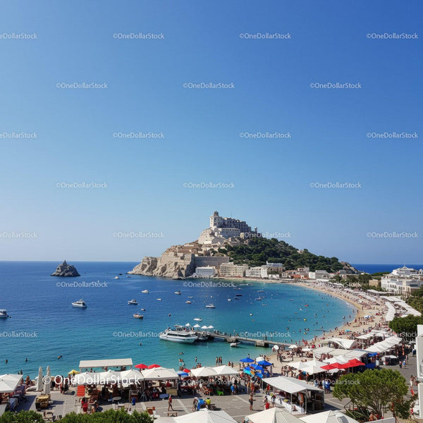 Scenic Coastal Town with Castle Overlooking a Vibrant Beach Scene