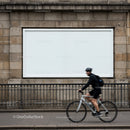 Cyclist passing outdoor blank advertising billboard