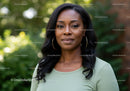 Confident woman posing outdoors with natural background