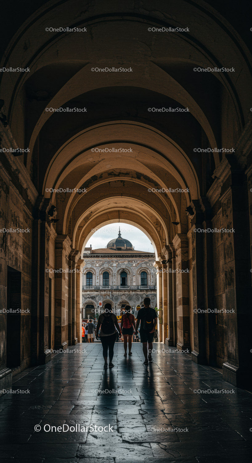 Historic Archway with Tourists and City Skyline Backdrop