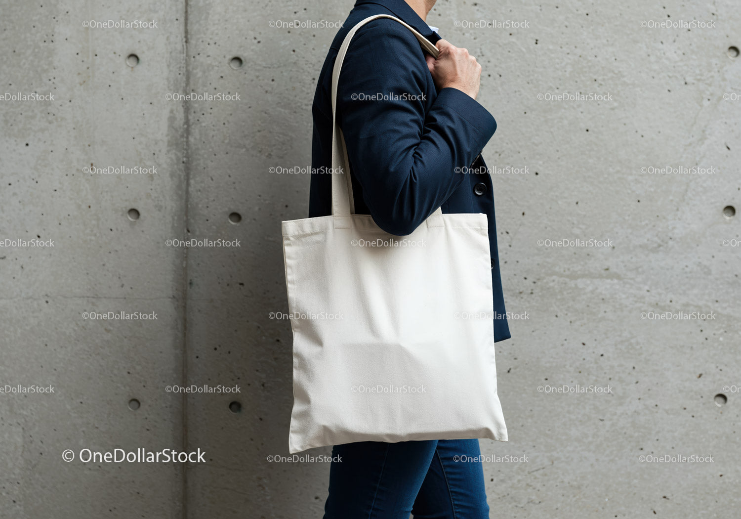 Person carrying blank white tote bag in urban setting