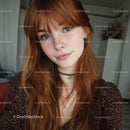 Young Woman with Red Hair and Bright Blue Eyes Indoors