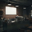 Barista working behind coffee bar in cozy cafe interior