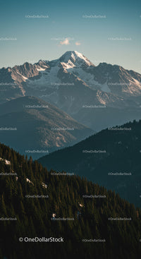 Majestic Snow-Covered Mountain Peak with Forested Hills