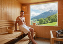 Man Relaxing in Wooden Sauna with Mountain View