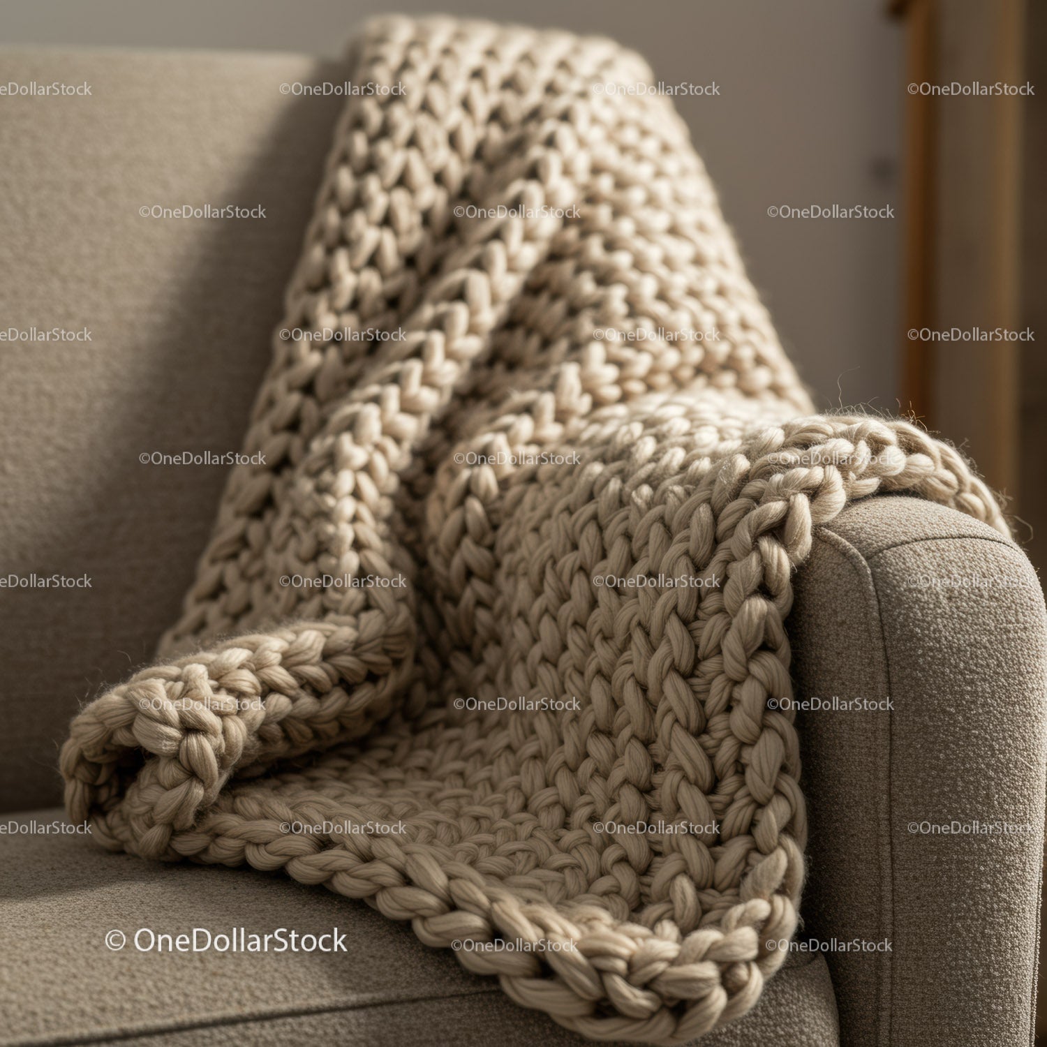 Cozy beige chunky knit blanket on textured armchair