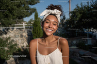 Joyful Young Woman Smiling Outdoors in Summer Light