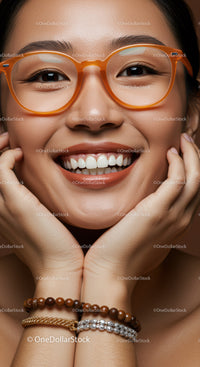 Close-up portrait of smiling woman with orange glasses