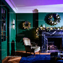 Cozy living room with festive Christmas wreaths and fireplace