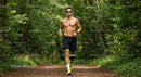 Male Athlete Running in Nature Trail with Prosthetic Leg