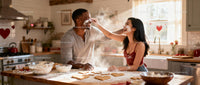 Couple Playfully Baking Heart Shaped Cookies Together