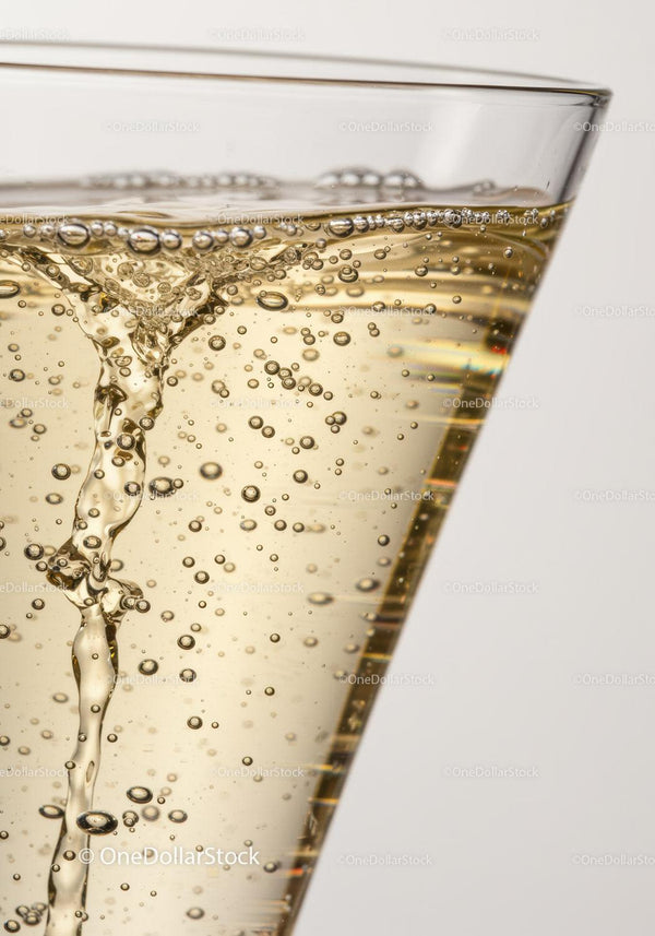 Effervescent Bubbles Rising in Clear Champagne Glass