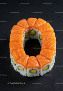 Fresh salmon avocado sushi ring on dark slate plate
