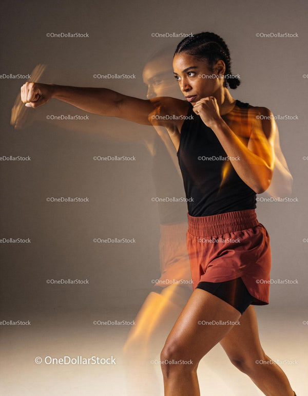 Focused woman practicing martial arts punch motion