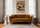 Modern cozy living room with orange velvet sofa and decor