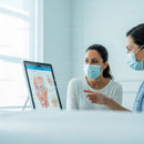 Medical Professionals Discuss Anatomy Chart in Clinic