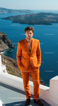 Man in Orange Suit Posing by Coastal Cliffs and Sea