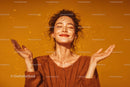 Joyful Woman Relaxing Outdoors in Bright Orange Background