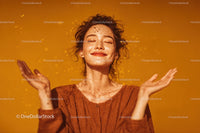 Joyful Woman Relaxing Outdoors in Bright Orange Background