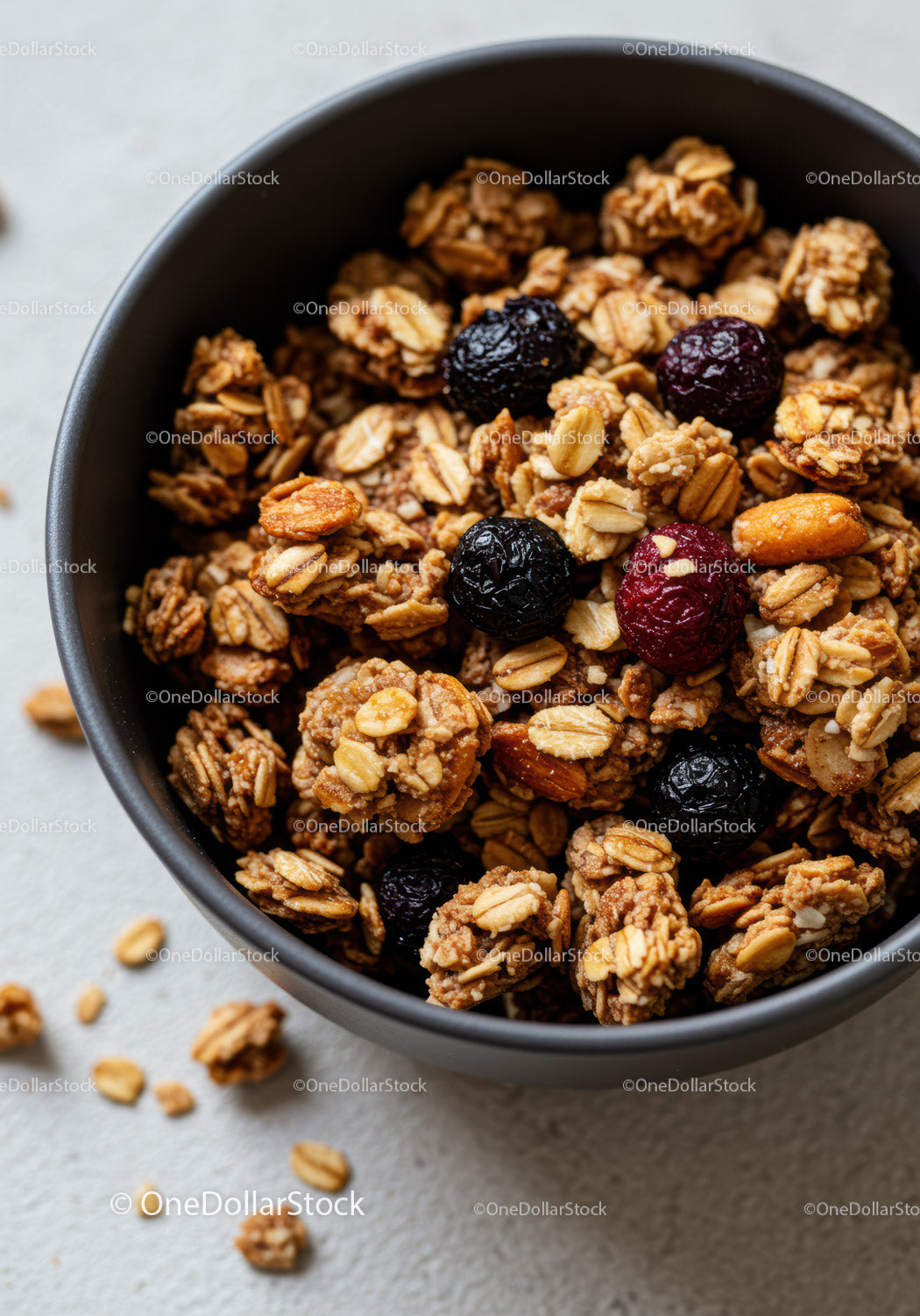 Crunchy granola with dried berries in a dark bowl