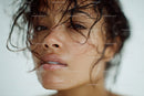 Close-up of a Woman with Wet Curly Hair and Sunlit Skin