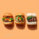 Gourmet Burger with Lettuce and Tomato Next to Grilled Steak and Dumpling