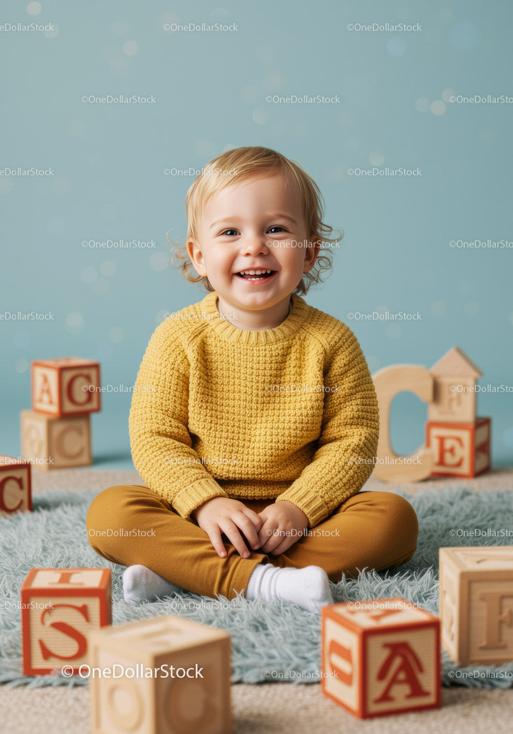 Smiling toddler sitting on soft rug with wooden blocks