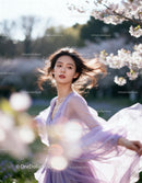 Graceful woman twirling in lavender dress outdoors