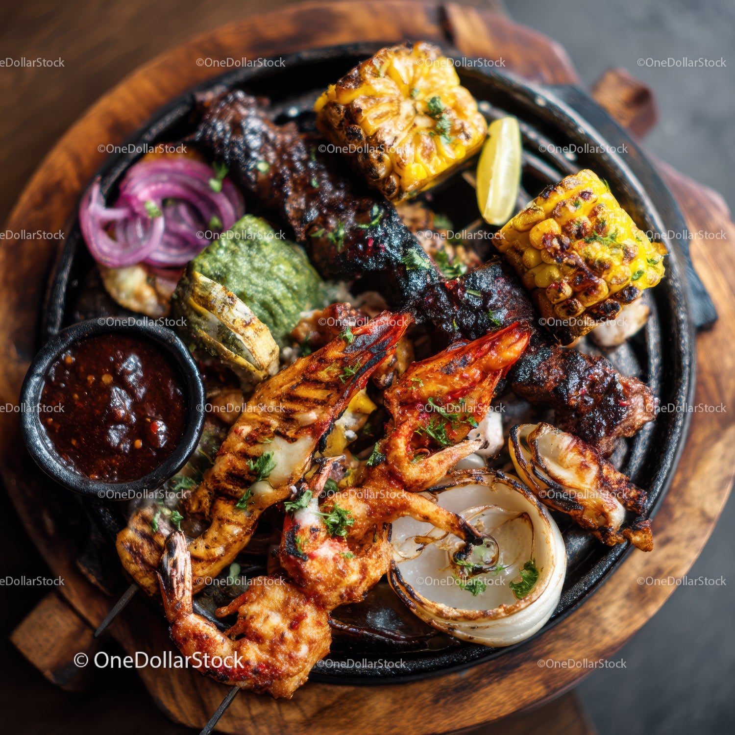 Seafood platter with grilled shrimp, squid, corn, and spicy sauce