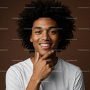 Young Man with Curly Hair Smiling Portrait in Casual White Shirt